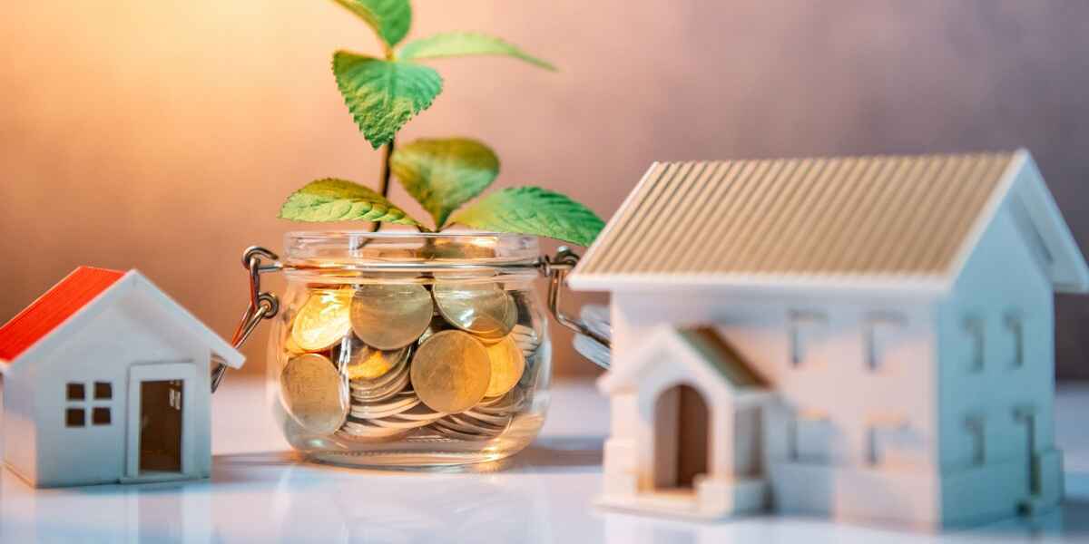 Coins in a jar next to small houses