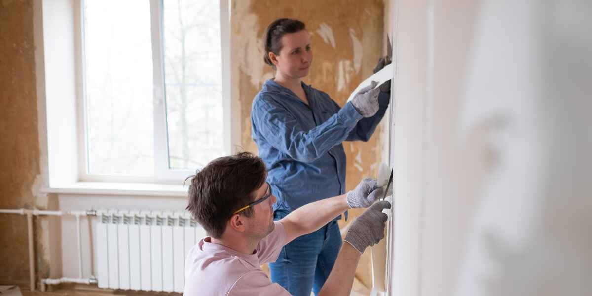 Two people renovating a home